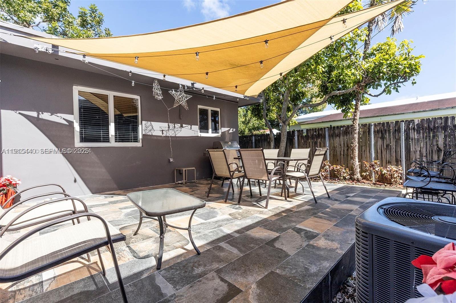 753 Northeast 81st Street Miami, FL 33138 - Photo 54 of 57 a view of a patio with table and chairs and potted plants