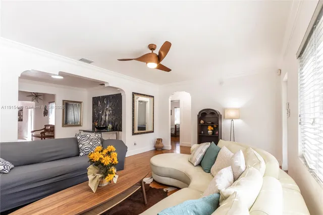a living room with furniture and wooden floor