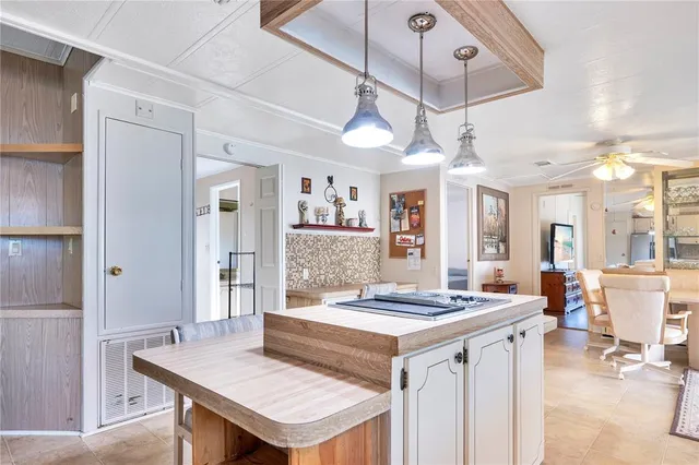 a living room with kitchen island furniture and a chandelier