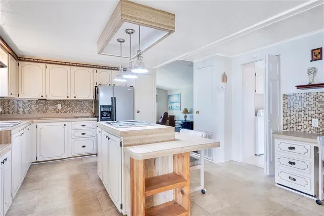 a kitchen with cabinets appliances and a counter space