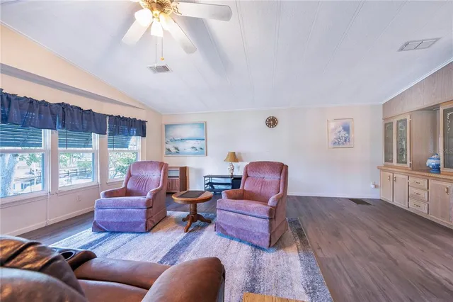 a living room with furniture fireplace and a large window