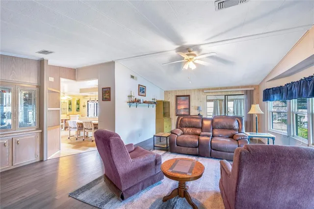 a living room with furniture a fireplace and a chandelier