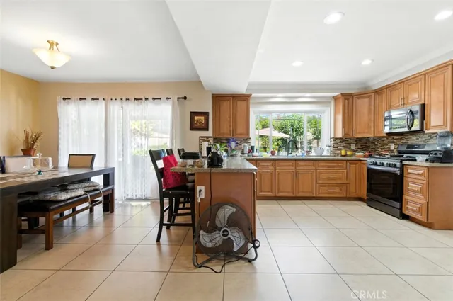 a kitchen with stainless steel appliances granite countertop a refrigerator and a stove top oven