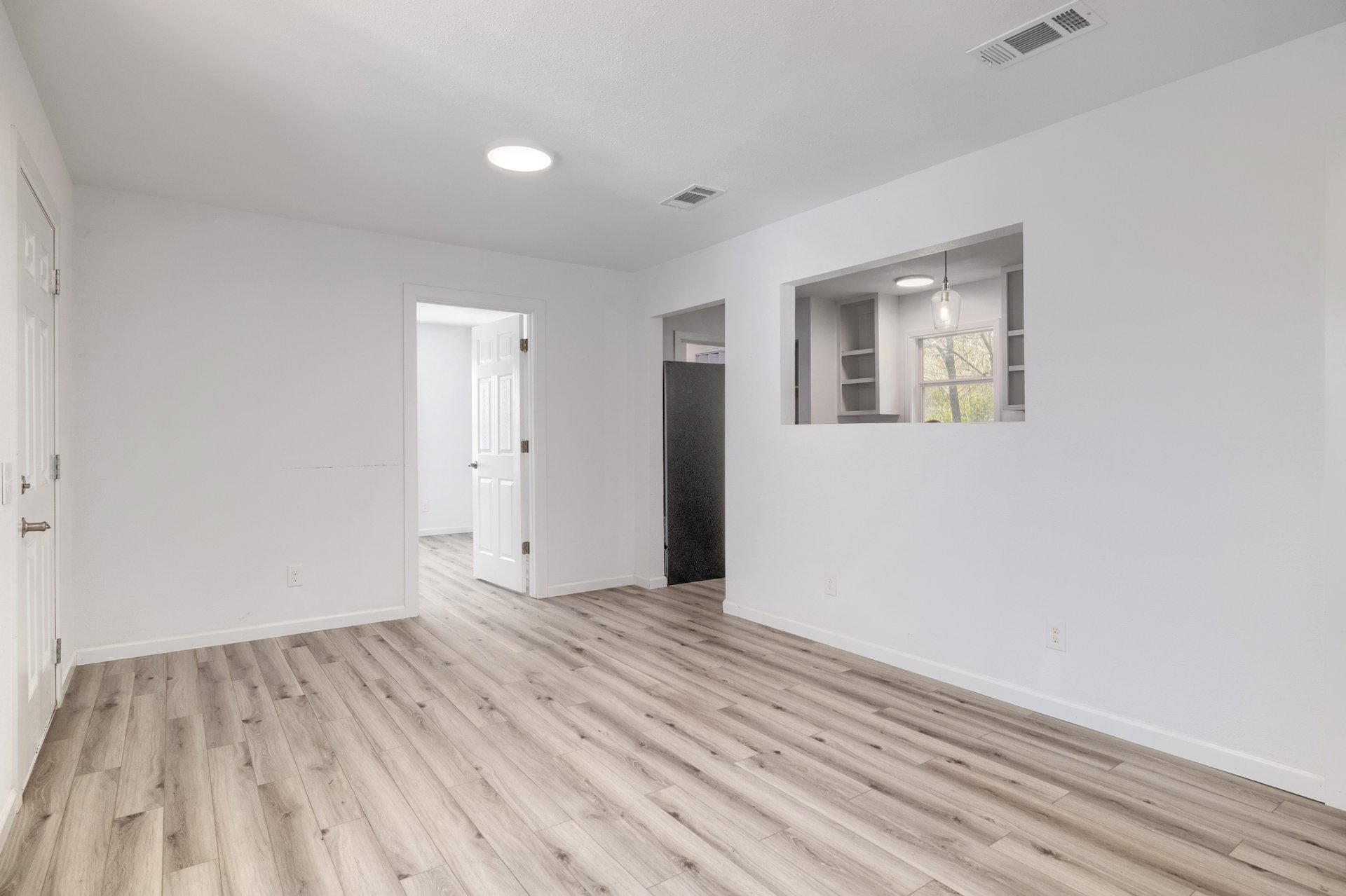 270 Kelley Road West Bastrop, TX 78602 - Photo 8 of 29 a view of an empty room with wooden floor and a window