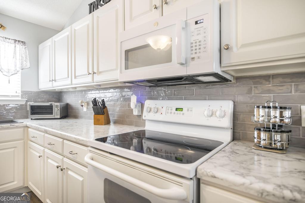 216 South Houston Springs Boulevard Perry, GA 31069 - Photo 15 of 31 a kitchen with a sink and cabinets