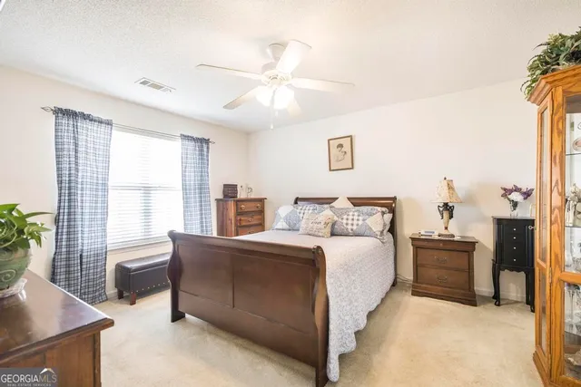 a spacious bedroom with a bed and a window