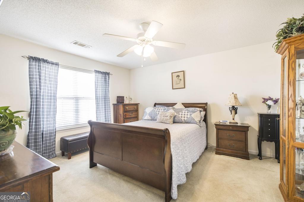 216 South Houston Springs Boulevard Perry, GA 31069 - Photo 17 of 31 a spacious bedroom with a bed and a window