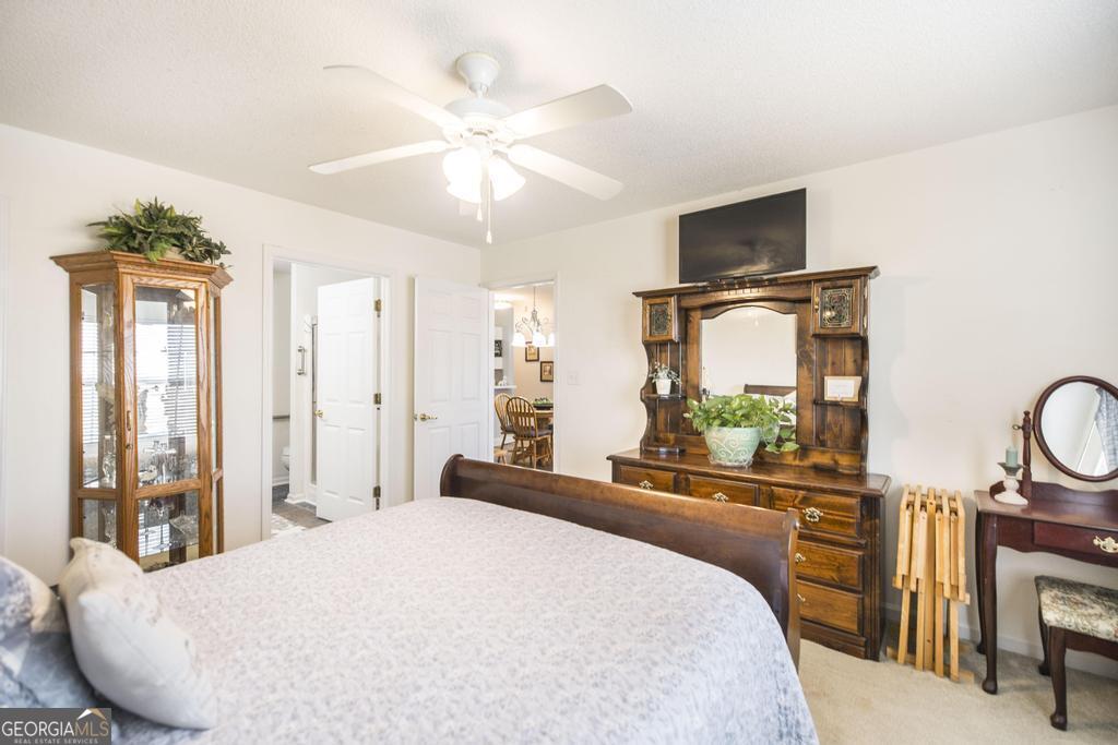 216 South Houston Springs Boulevard Perry, GA 31069 - Photo 18 of 31 a bedroom with a bed and a chandelier