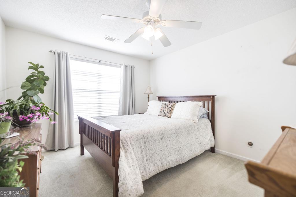 216 South Houston Springs Boulevard Perry, GA 31069 - Photo 23 of 31 a bedroom with a bed and a chandelier