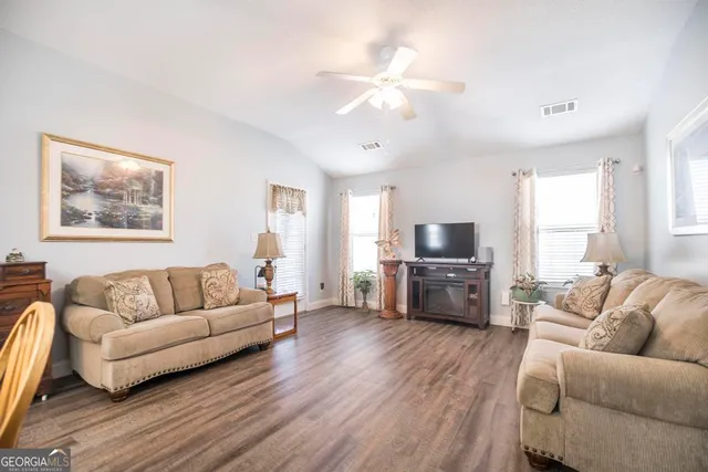 a living room with furniture and a flat screen tv