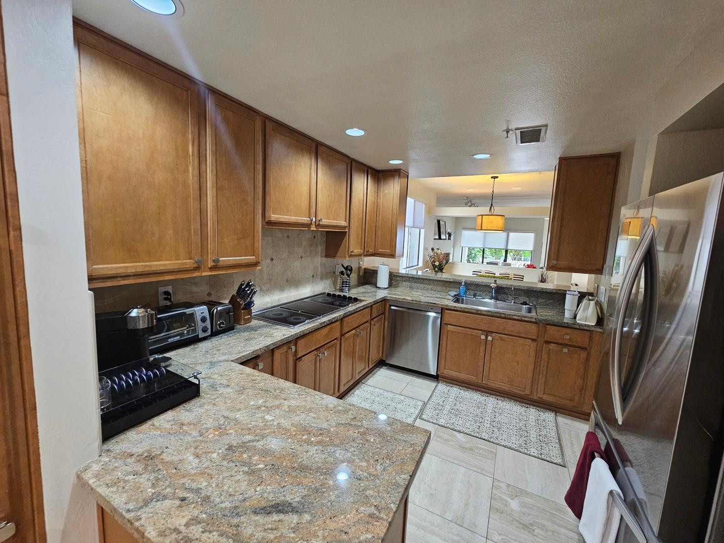 7700 East Gainey Ranch Road, Unit 153 Scottsdale, AZ 85258 - Photo 6 of 24 a kitchen with stainless steel appliances granite countertop a sink stove and refrigerator