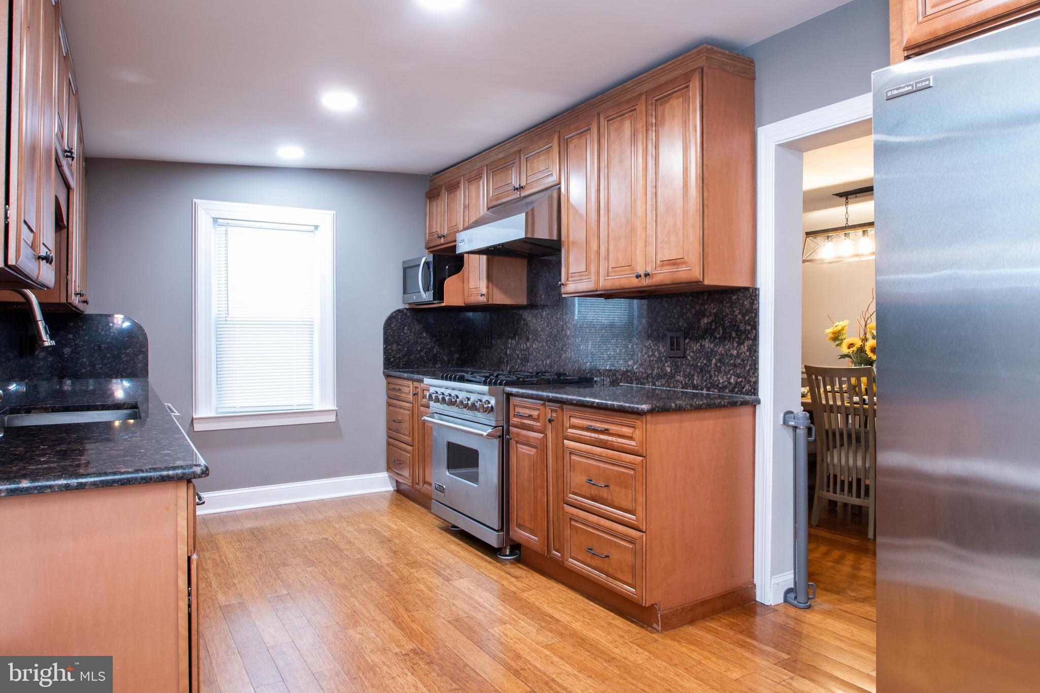 239 Main Street Hamilton, NJ 08620 - Photo 11 of 39 a kitchen with stainless steel appliances granite countertop a sink stove and refrigerator
