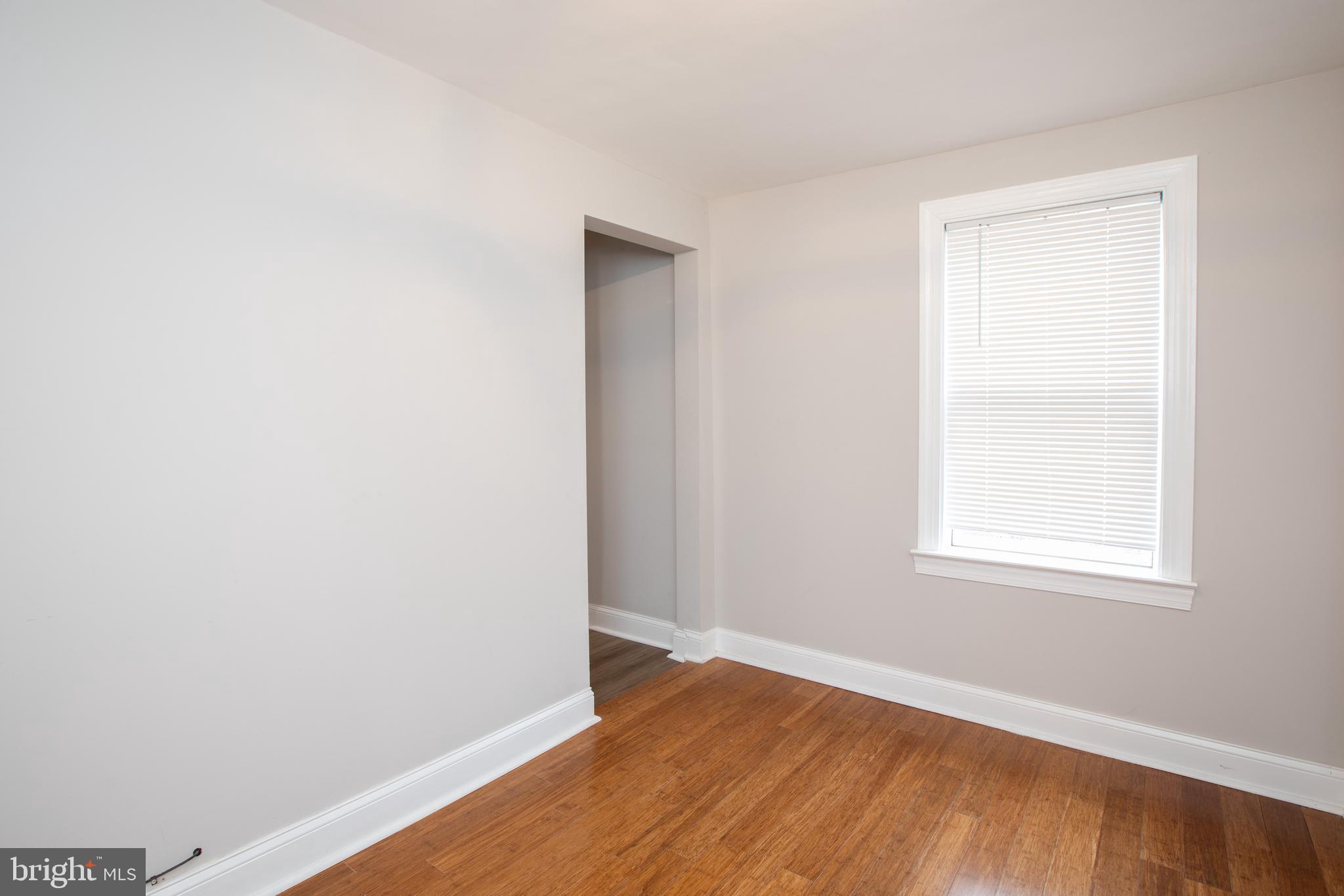 239 Main Street Hamilton, NJ 08620 - Photo 14 of 39 a view of an empty room with wooden floor and a window