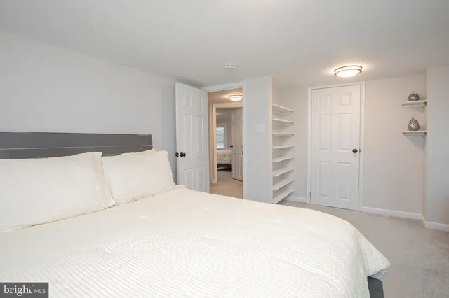 a large white bed in a white room