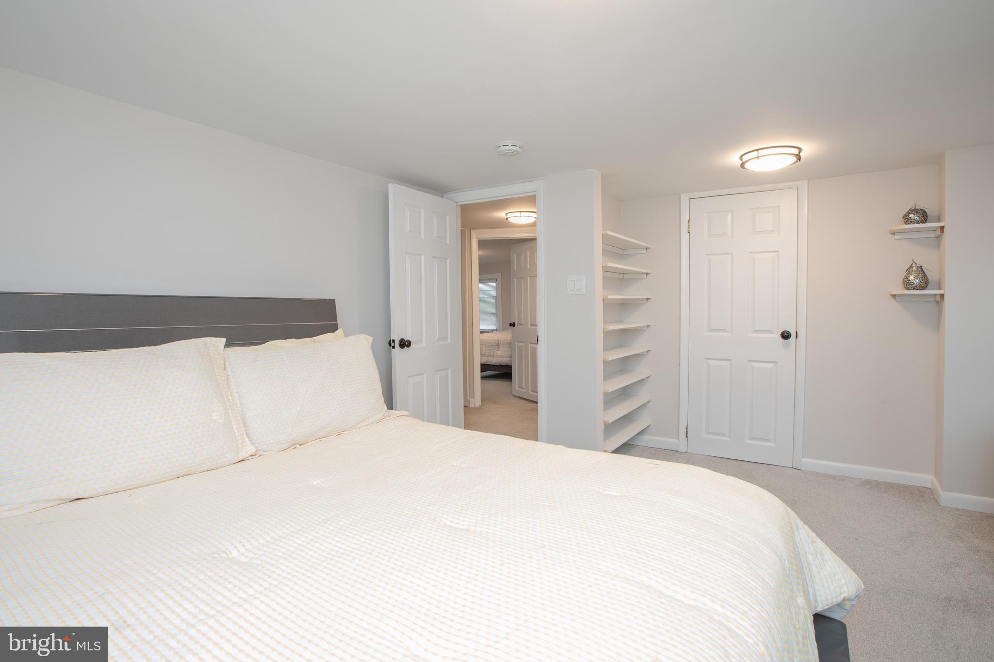 239 Main Street Hamilton, NJ 08620 - Photo 17 of 39 a large white bed in a white room