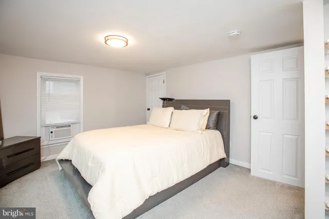 a bedroom with a bed and dresser