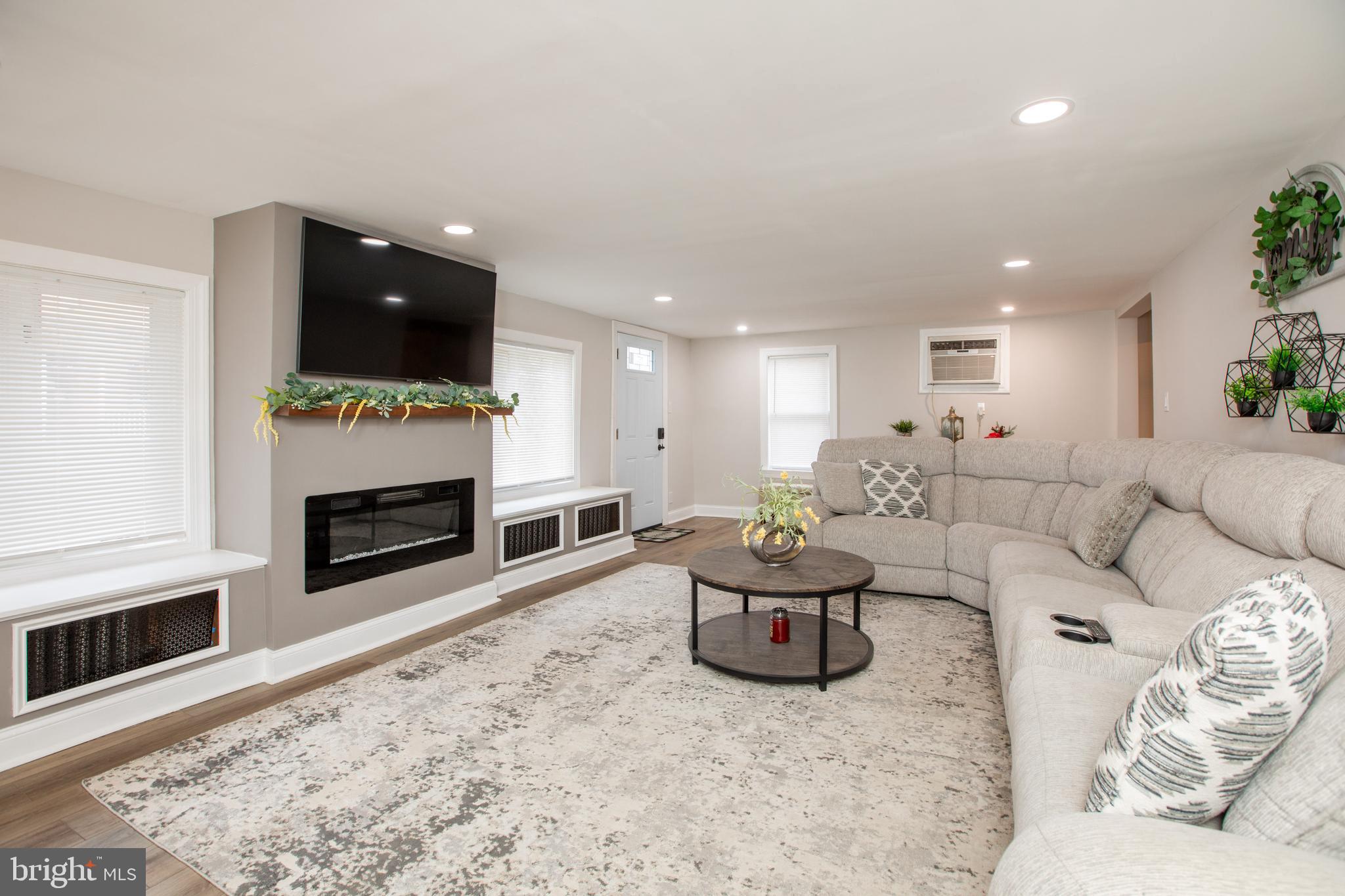 239 Main Street Hamilton, NJ 08620 - Photo 2 of 39 a living room with furniture and a fireplace