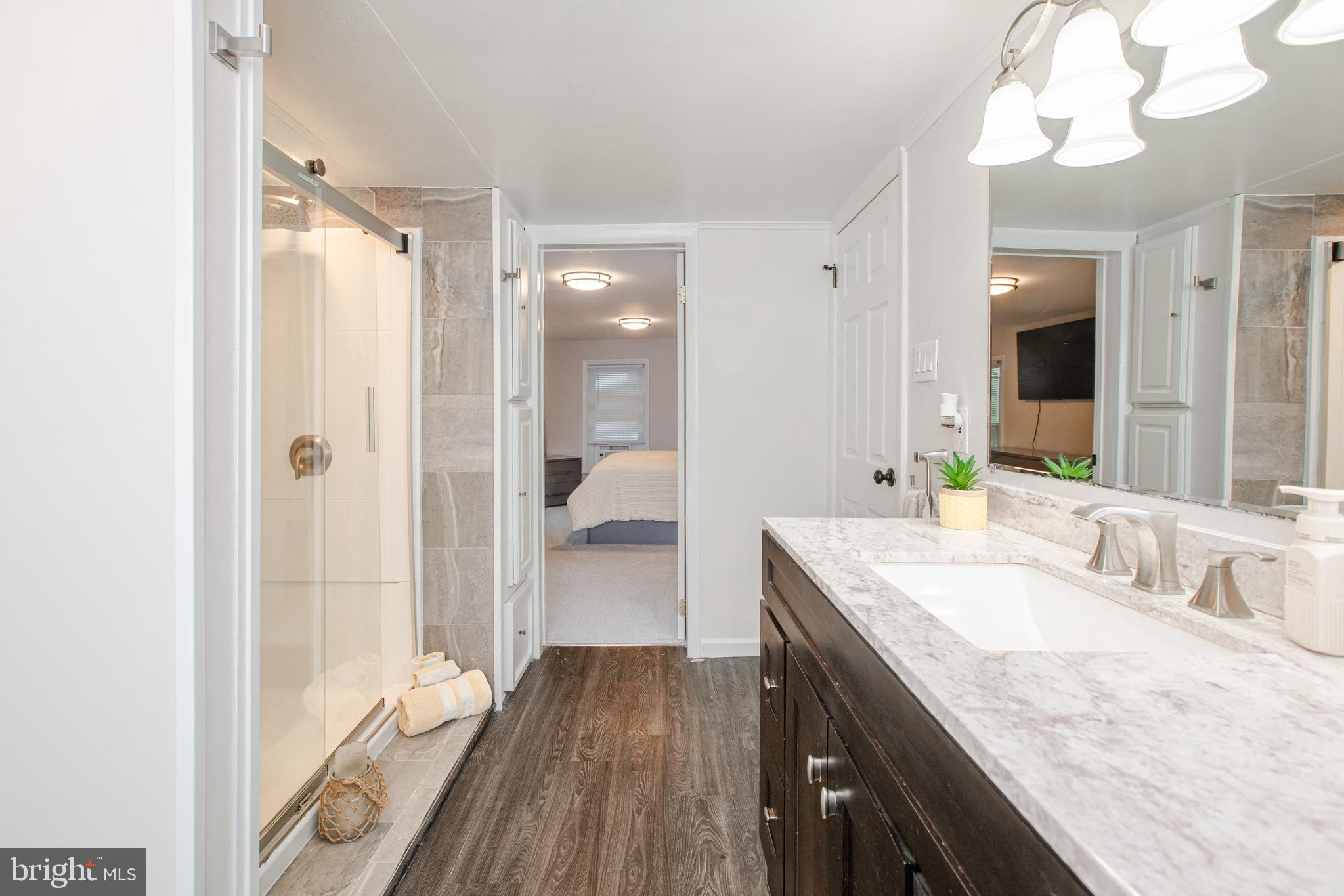 239 Main Street Hamilton, NJ 08620 - Photo 21 of 39 a bathroom with a granite countertop sink mirror and double