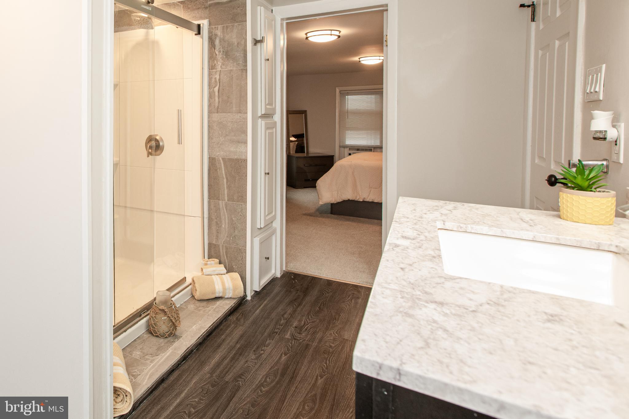 239 Main Street Hamilton, NJ 08620 - Photo 22 of 39 a en suite bathroom with a granite countertop sink and a mirror