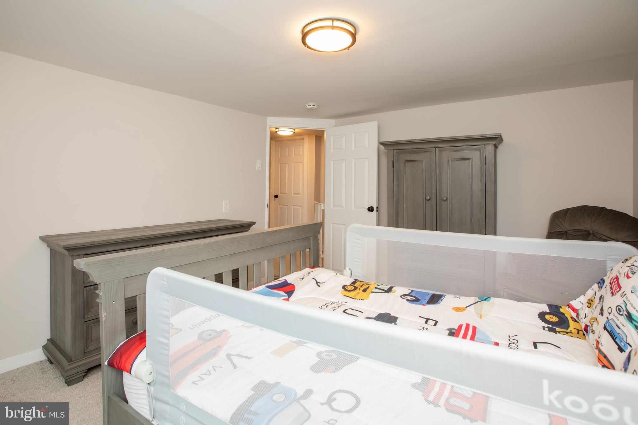 239 Main Street Hamilton, NJ 08620 - Photo 25 of 39 a bed sitting in a bedroom next to a window