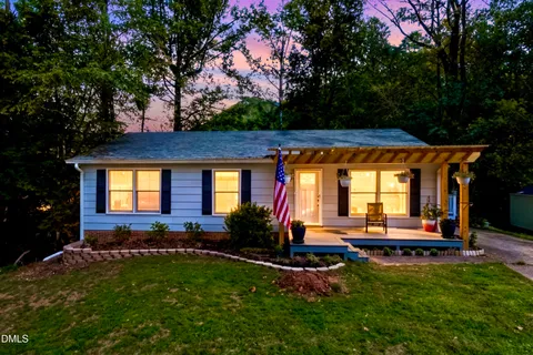 a front view of house with yard and outdoor seating