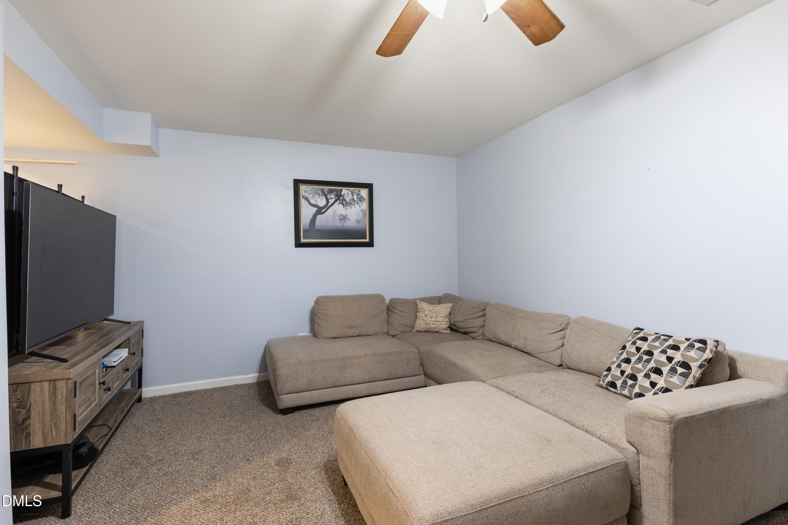 6125 Bellow Street Raleigh, NC 27609 - Photo 26 of 41 a living room with furniture and a flat screen tv
