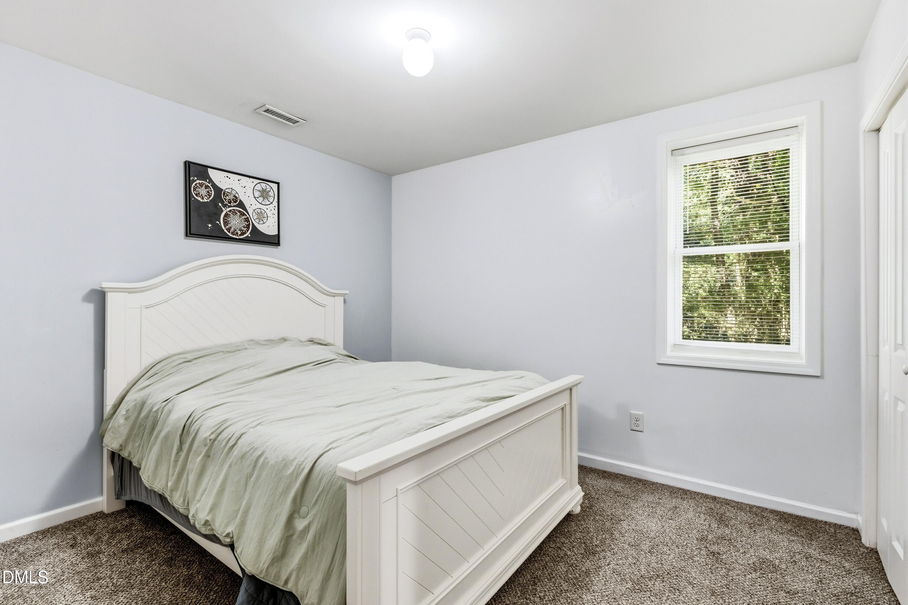 6125 Bellow Street Raleigh, NC 27609 - Photo 28 of 41 a bedroom with a bed and a window