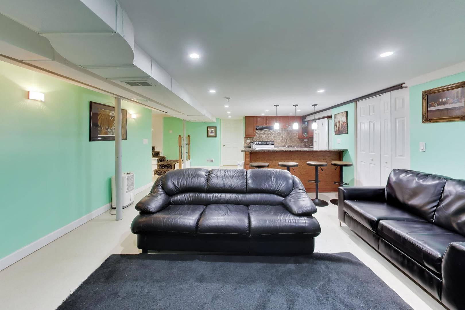458 West Alma Street Elmhurst, IL 60126 - Photo 17 of 29 a living room with furniture and a flat screen tv
