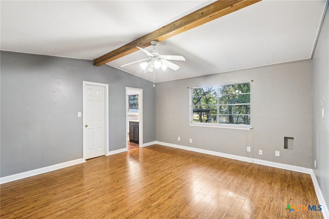 24007 Windy Valley Road Leander, TX 78641 - Photo 11 of 24 a view of an empty room with window and wooden floor