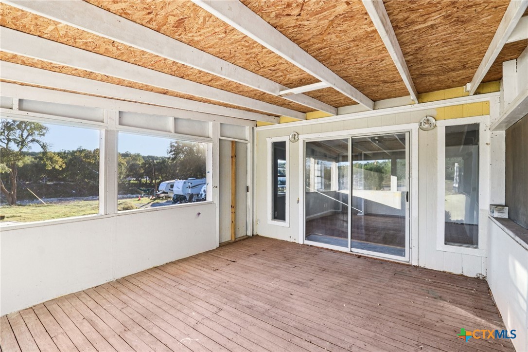 24007 Windy Valley Road Leander, TX 78641 - Photo 15 of 24 a view of an empty room with wooden floor and a fireplace