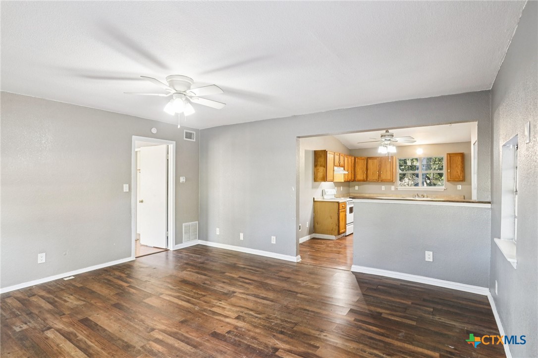 24007 Windy Valley Road Leander, TX 78641 - Photo 5 of 24 a view of an empty room with window and wooden floor
