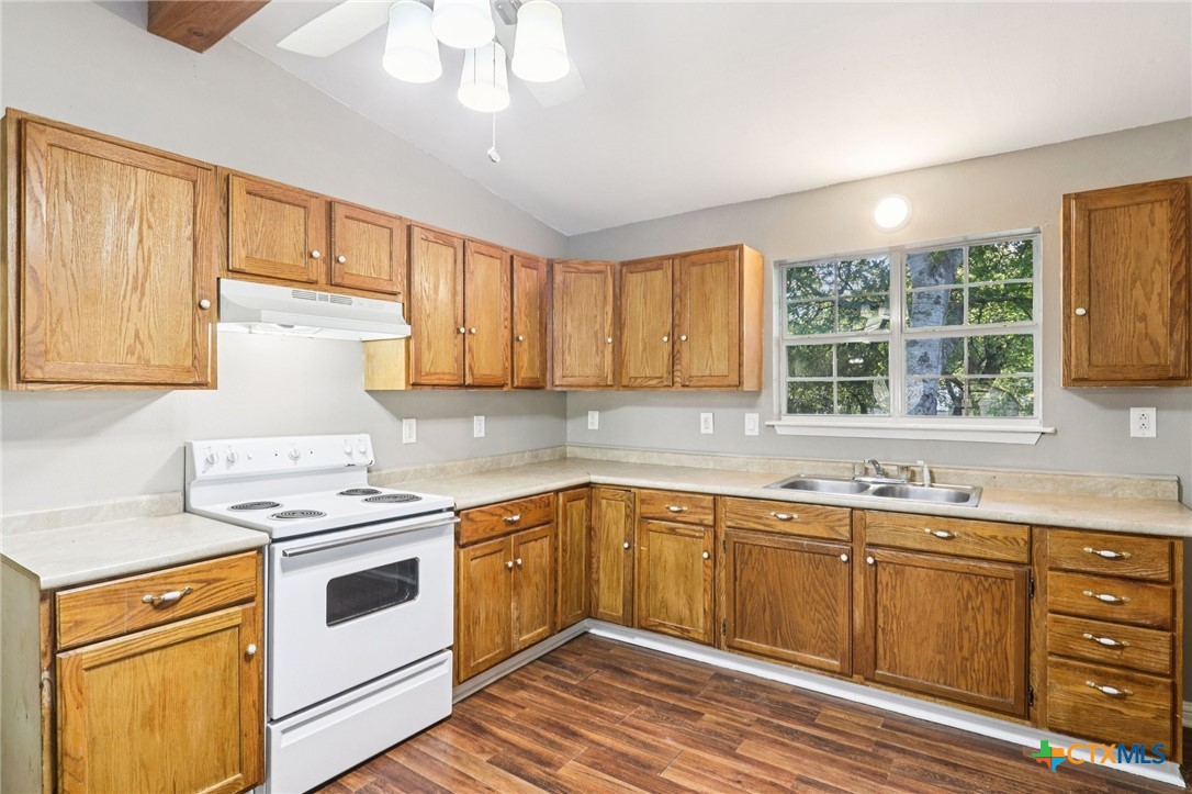 24007 Windy Valley Road Leander, TX 78641 - Photo 7 of 24 a kitchen with a white stove top oven sink and cabinets