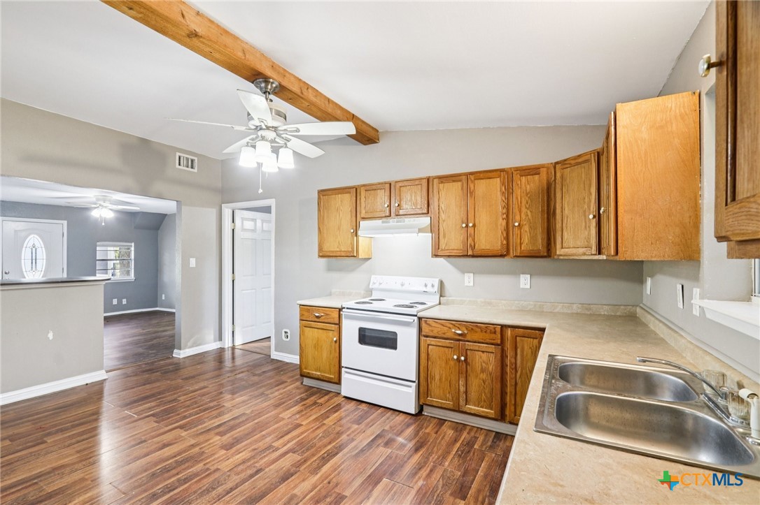 24007 Windy Valley Road Leander, TX 78641 - Photo 8 of 24 a kitchen with a stove a sink and a refrigerator