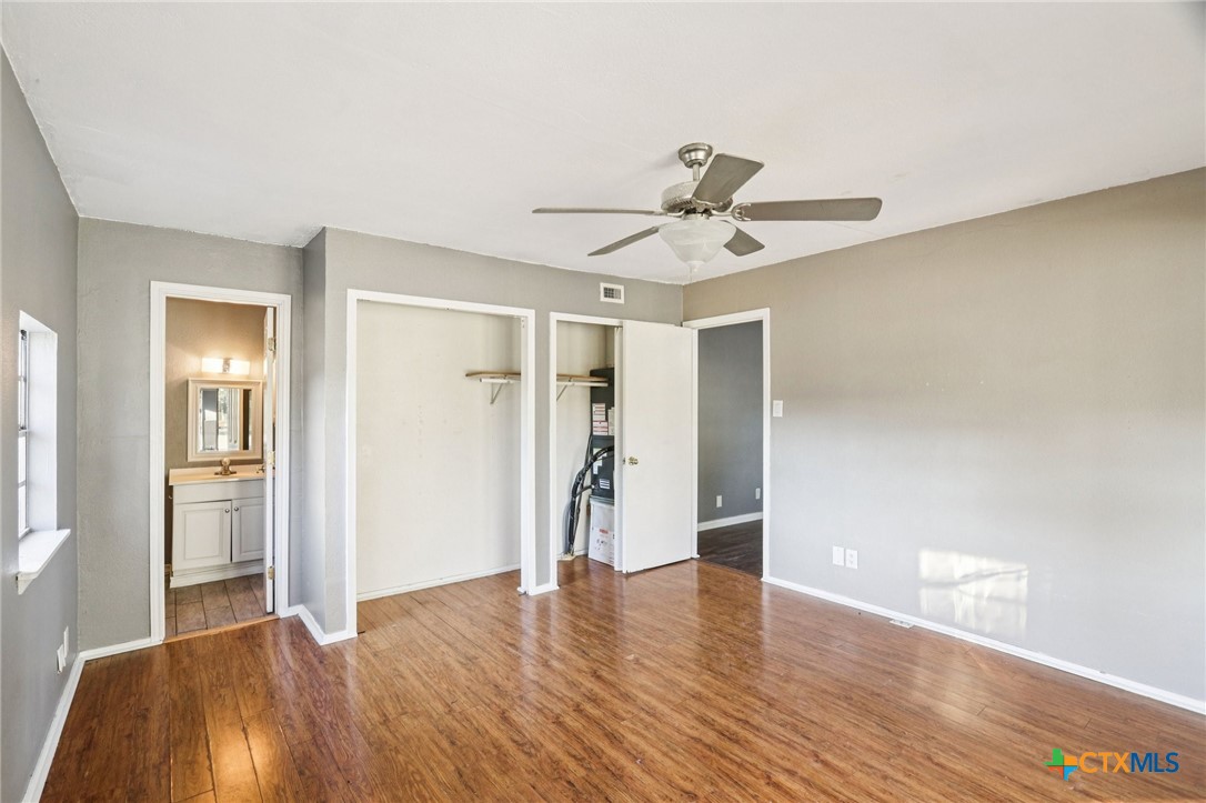 24007 Windy Valley Road Leander, TX 78641 - Photo 9 of 24 a view of empty room with wooden floor and ceiling fan