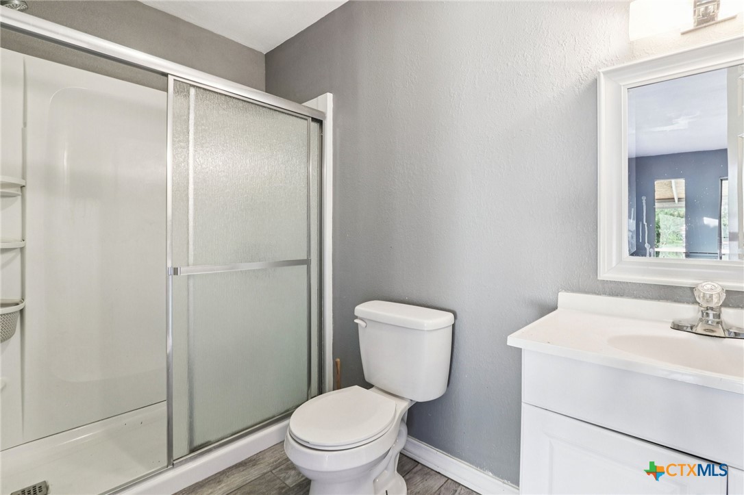 24007 Windy Valley Road Leander, TX 78641 - Photo 10 of 24 a white toilet sitting next to a bathroom sink