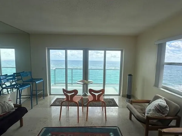 a living room with furniture and a large window