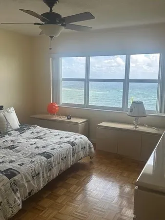 a bedroom with a bed and a large window