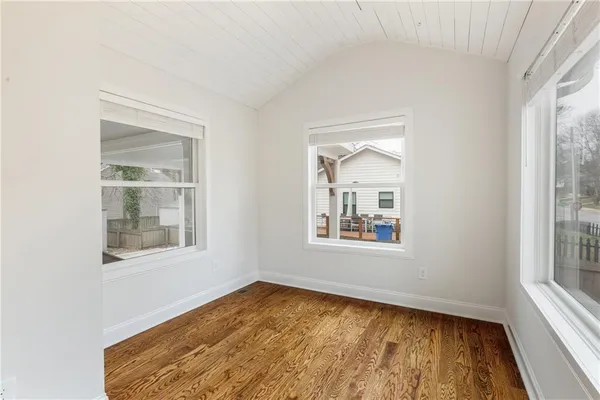a view of a hallway view with wooden floor and staircase