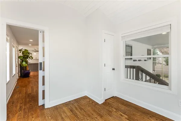 a view of an empty room with wooden floor