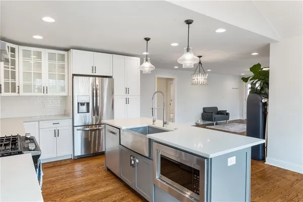 a kitchen with stainless steel appliances a sink stove and refrigerator