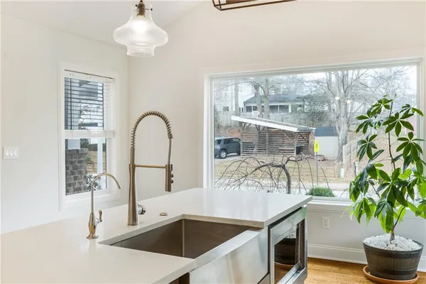 a kitchen with a sink a stove a refrigerator and white cabinets
