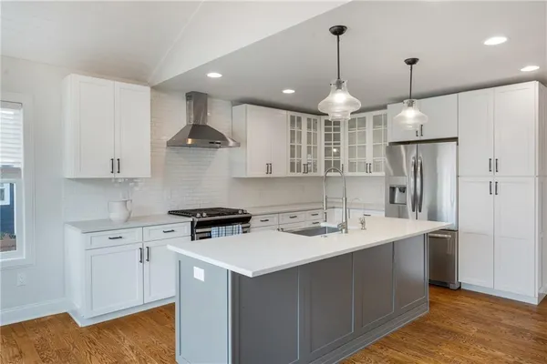 a kitchen with a sink and chandelier