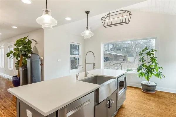 a kitchen with a sink a stove and cabinets