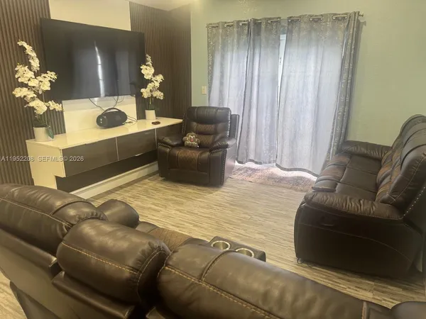 a living room with furniture and flowers