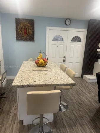 a dining table with chair and wooden floor