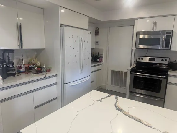 a kitchen with a refrigerator stove and microwave