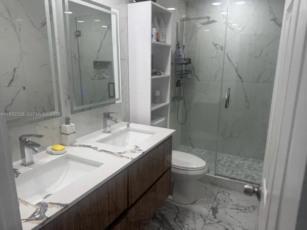 a bathroom with a sink toilet and shower