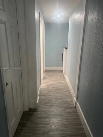 a view of hallway with wooden floor