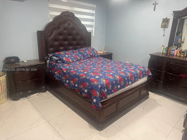 a bed sitting in a bedroom next to a window