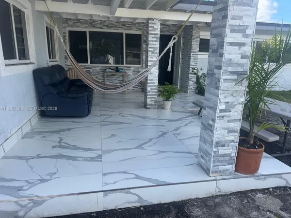 a view of house with outdoor seating space